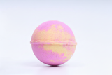 Pink and yellow bath bomb on a light background