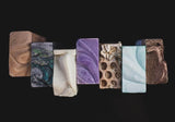 Top view of 7 different soaps in a jagged line