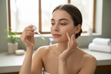 woman applying serum to face